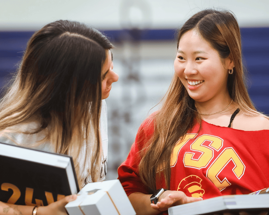 students-looking-at-yearbooks-during-senior-celebration