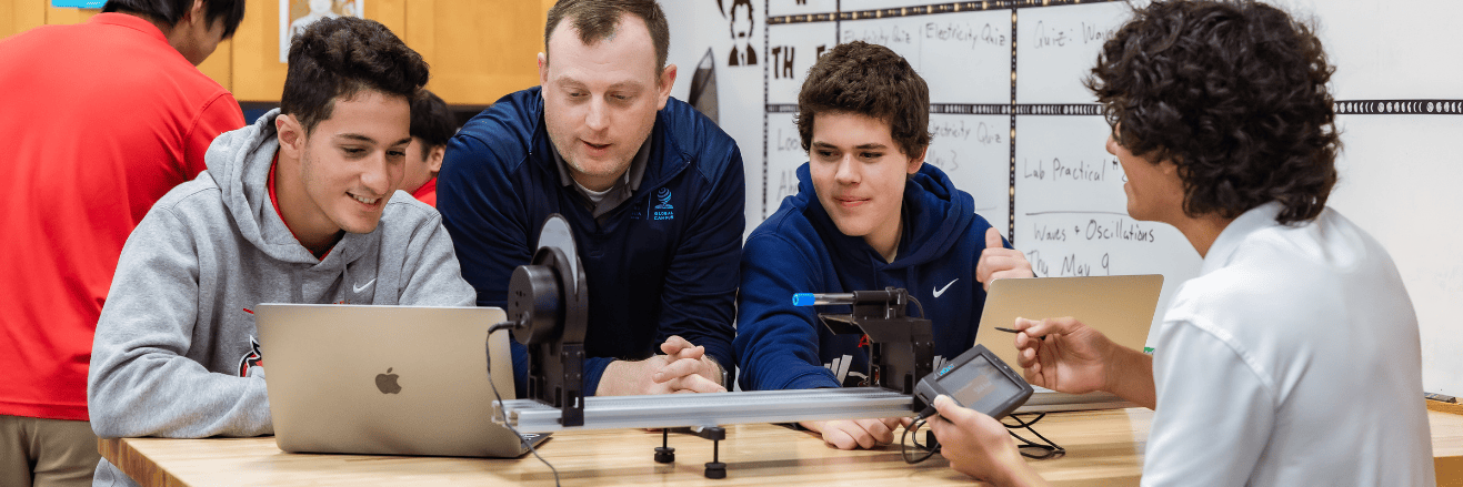 students-and-teacher-learning-in-ib-physics-class-with-laptop