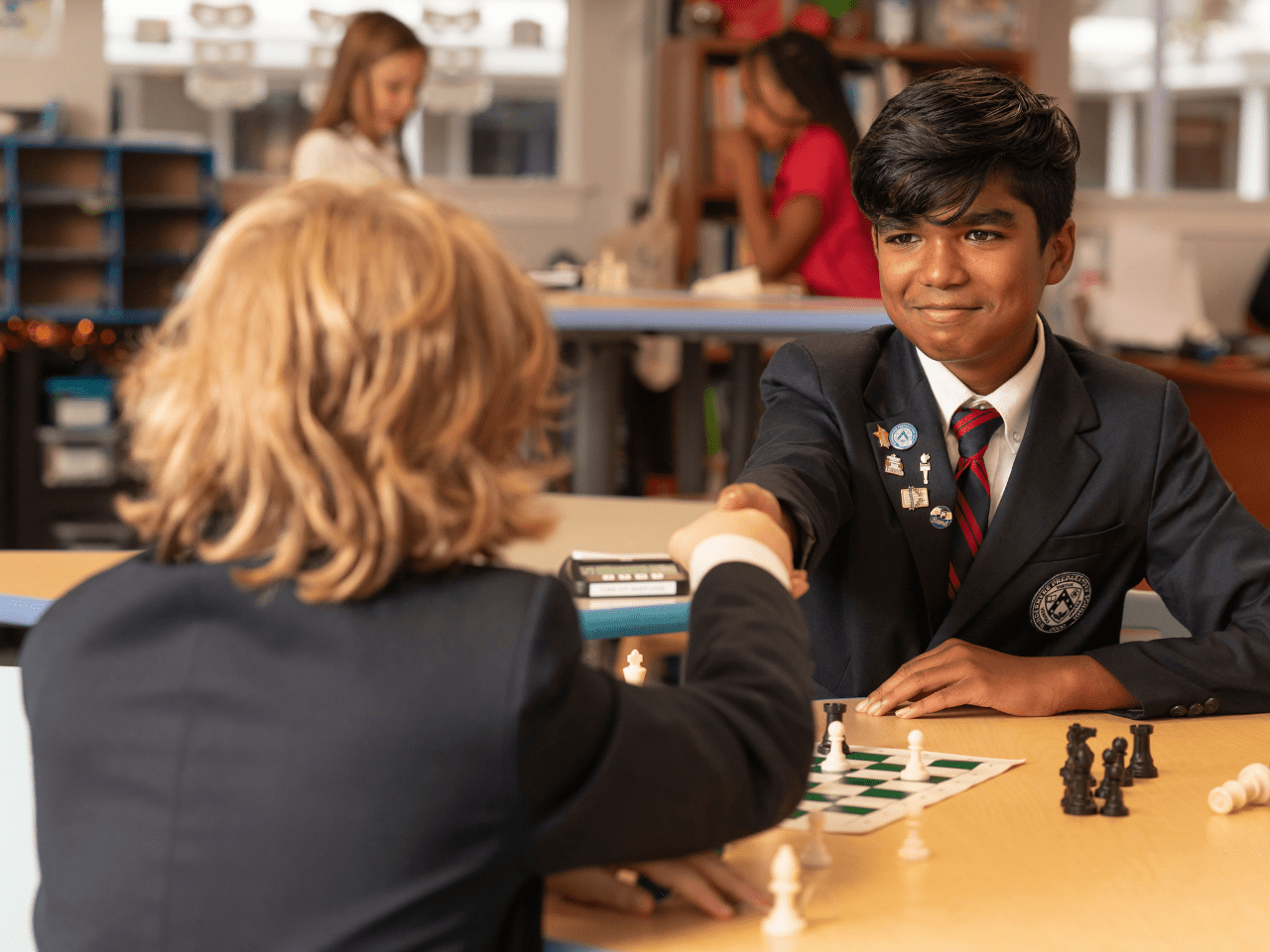 How to effectively balance schoolwork and extracurricular activities-How to effectively balance schoolwork and extracurricular activities-wps-students-shaking-hands-after-a-chess-game-min
