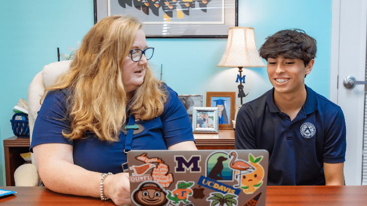 Windermere Prep college counselor meeting with a high school student to discuss college planning.