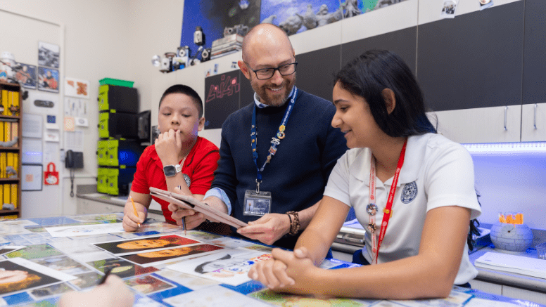 Windermere Prep teacher working with students on a collaborative classroom project.