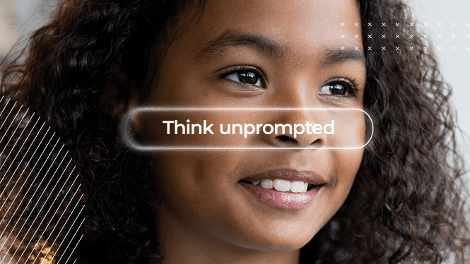 Close-up portrait of a smiling student with curly hair looking thoughtfully into the distance. A translucent search-bar-style graphic overlays the center of the image with the words “Think unprompted."
