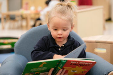 A young student reading a book